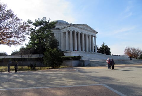 Pedestrians stand in front of the staircase and front entrance to the Thomas Jefferson Memorial in Washington, DC.