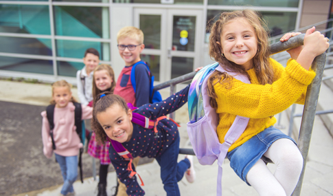 Group of kids on the school background having fun