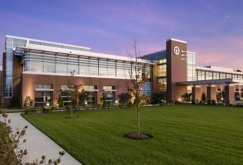 Twilight view of main entrance to LifeNet Health headquarters building.