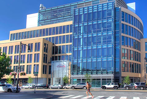 A jogger runs past Takeda’s new facility at 300 Massachusetts Avenue in Cambridge.