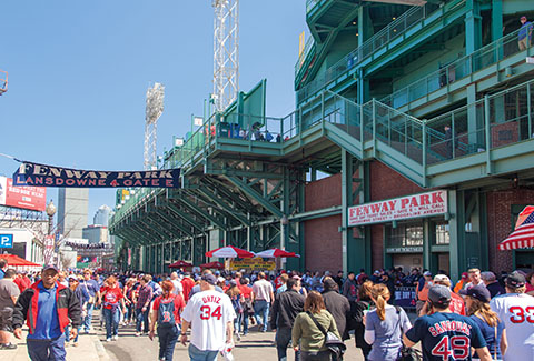 Pedestrians stroll along Lansdowne Street outside of Fenway Park in Boston.