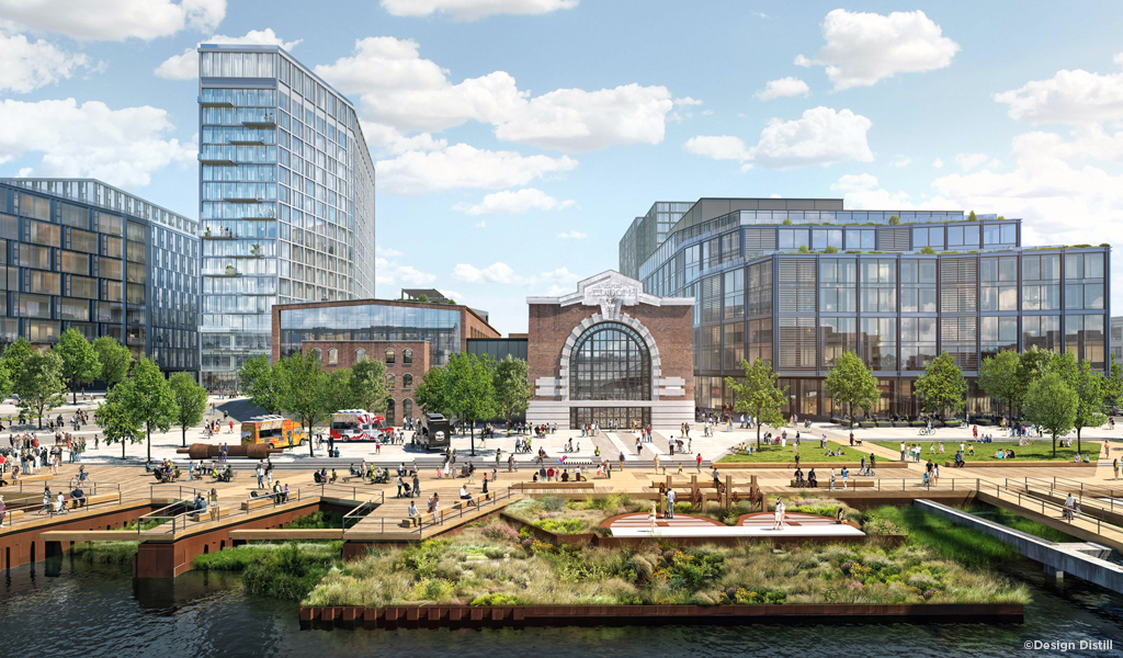 View from the waterfront depicting people walking on the boardwalks and using the public open space with the renovated turbine halls in the background set amongst the mixed-use development.