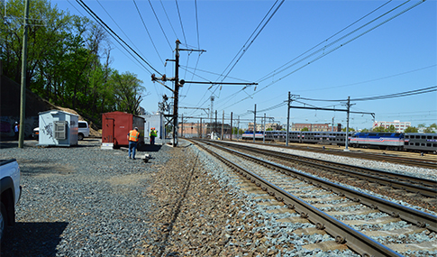 Construction crew working alongside train tracks