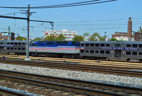 VRE engine and passenger car stationed in railyard