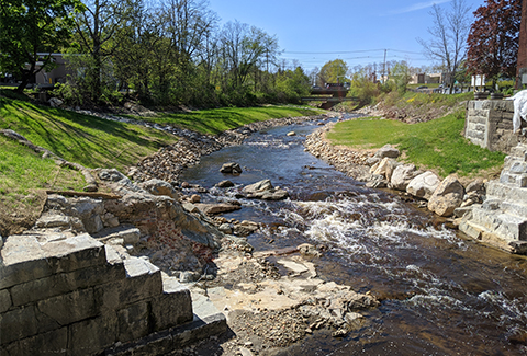 The now free-flowing Bellamy River runs between the remnants of the former upper dam.