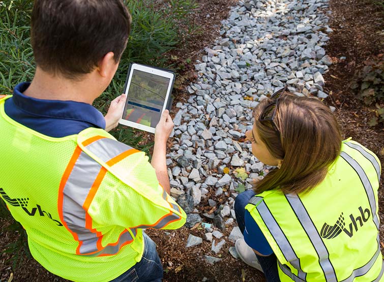 VHB personnel with vests conducting analysis on tablet