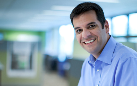 Fabricio with dark hair wearing a blue button down shirt.