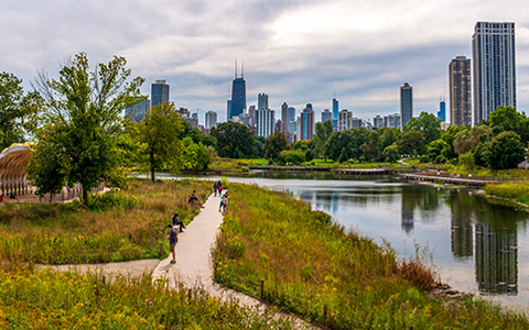 View of Jackson Park with walkways, water, and Chicago skyline in background