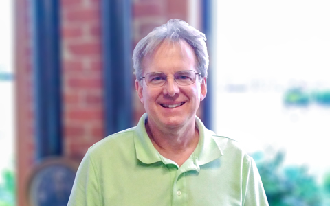 Man wearing glasses in polo shirt