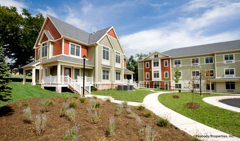 Apartment building with sidewalks and landscaping.