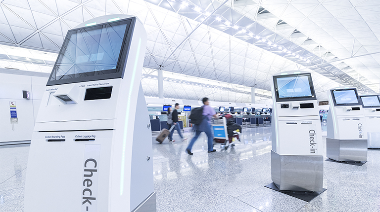 Self service machine and help desk kiosk at airport for check in, printing boarding pass or buying ticket