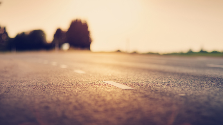 black asphalt road and white dividing lines