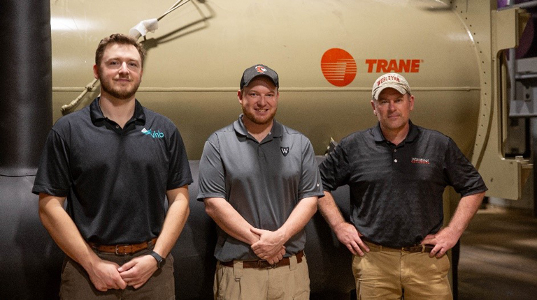 3 Men in front of new heater system 