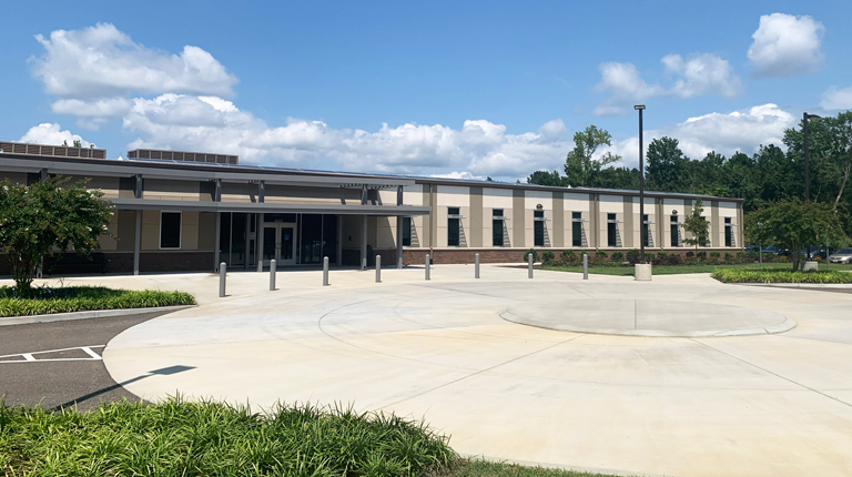 Front facade of East Center Mental Health building and front entrance roundabout. 