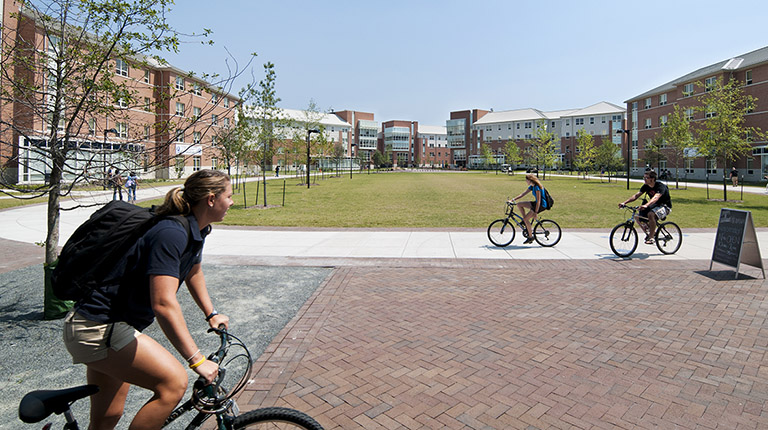 Students bike through Old Dominion University’s campus on a sunny day