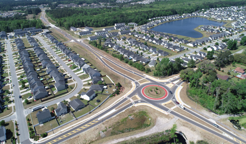 An aerial view of the Benton Boulevard at Meinhard Road roundabout is shown with surrounding neighborhoods.