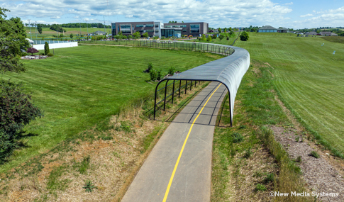 Protective fencing over a section of the trail to shield users from the adjacent Heritage Oaks golf course driving range. 