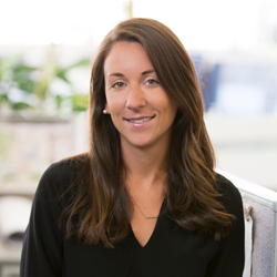 Jocelyn Gambone wearing a black shirt and sitting in the office