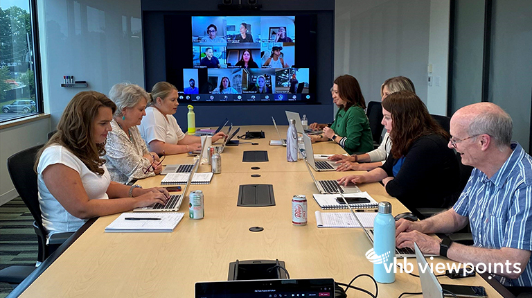 VHB team members conduct a hybrid meeting, with some in-person and some participating on screen