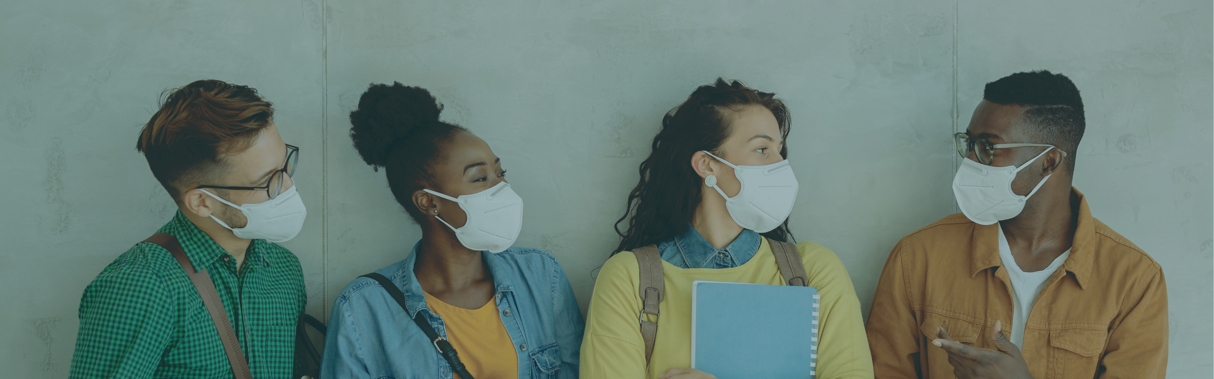 Four college students wearing masks.